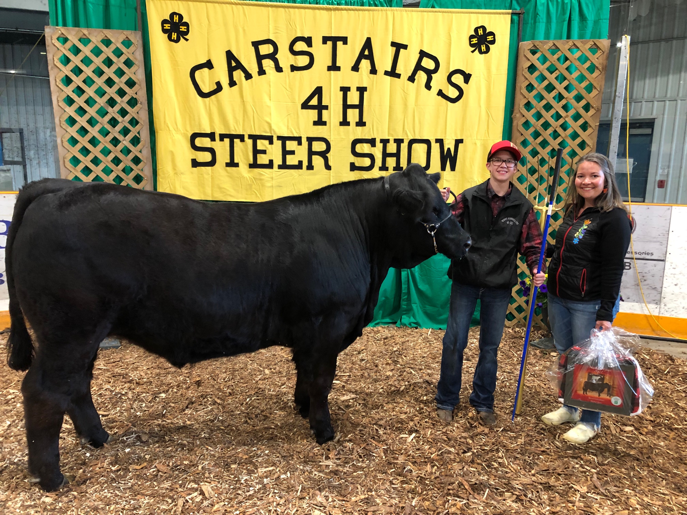 Indigenous Relations Manager Thalia Aspeslet and Rowan stand next to Rowan's large black Steer 