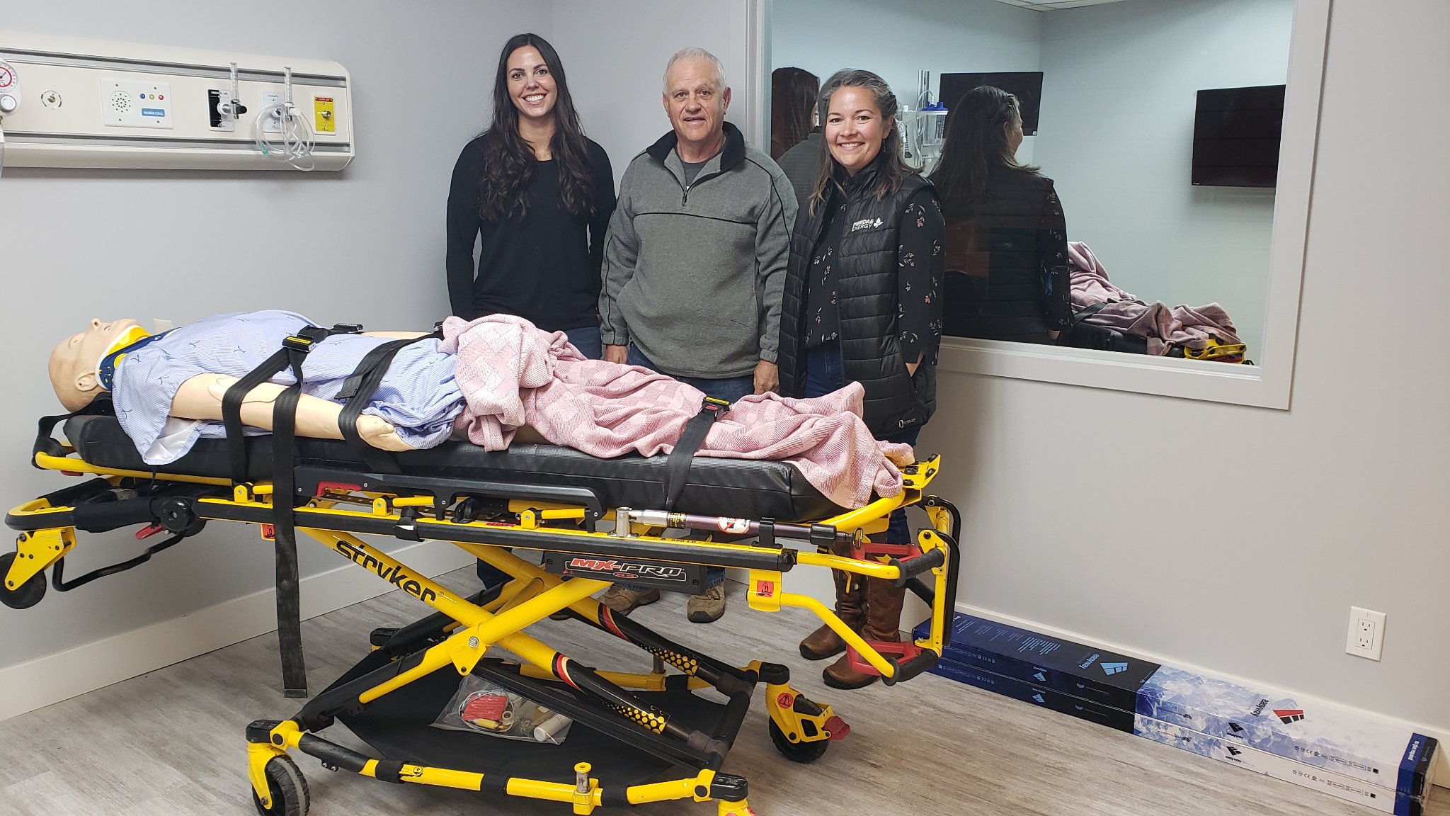Environmental Coordinator Karlee Overguard, Community Liaison Officer Thalia Aspeslet, join Sundre Hospital Futures Chair Gerald Ingeveld at the lab